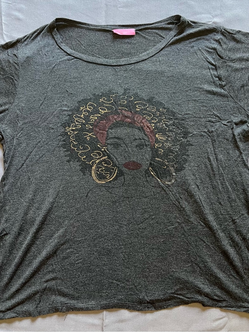 Ragdoll Black Short-Sleeve Graphic Tee with Gold Accents and Red Headwrap